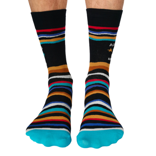 A close-up of Uptown Sox's Adulting Socks featuring funny illustrations and phrases about the challenges of adult life, perfect for anyone who can relate to the ups and downs of growing up.