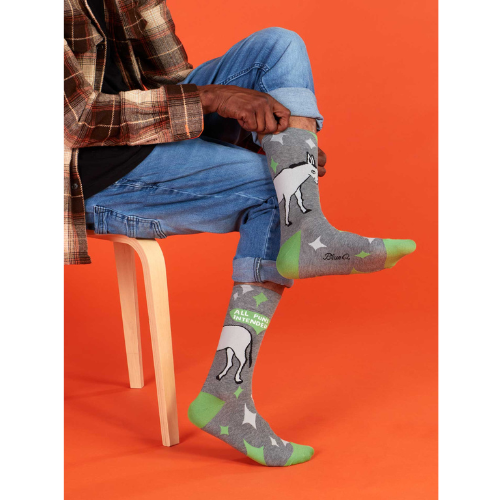 A pair of colorful Blue Q socks with the phrase 'All Puns Intended' and playful graphics, designed for pun enthusiasts and witty sock lovers.
