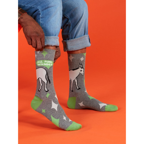A pair of colorful Blue Q socks with the phrase 'All Puns Intended' and playful graphics, designed for pun enthusiasts and witty sock lovers.