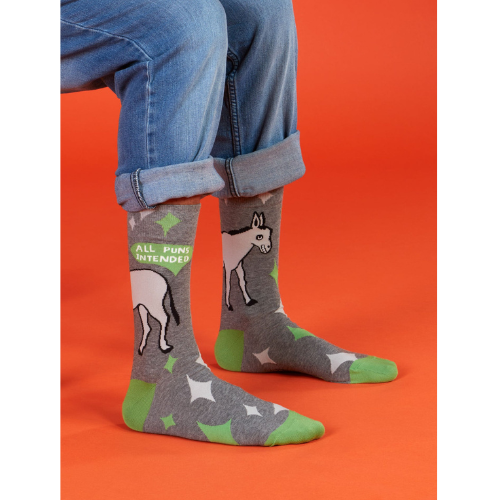 A pair of colorful Blue Q socks with the phrase 'All Puns Intended' and playful graphics, designed for pun enthusiasts and witty sock lovers.
