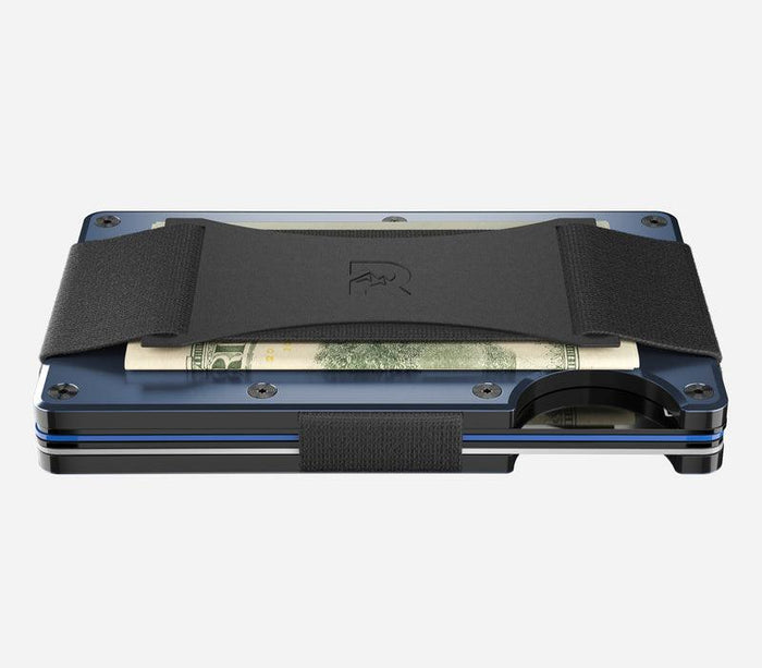 Angled view of the Alpine Navy Ridge aluminum minimalist wallet with cash strap