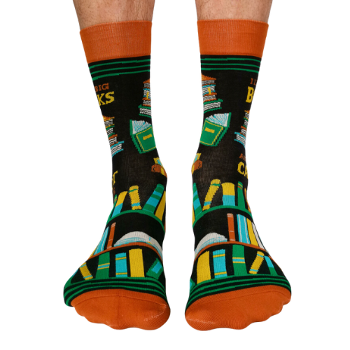 Pair of men's crew socks in orange, green, and black with a bookshelf design and the phrase 'I Like Big Books and I Cannot Lie' displayed on the side.