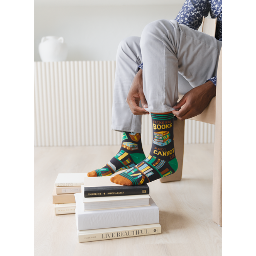 Pair of men's crew socks in orange, green, and black with a bookshelf design and the phrase 'I Like Big Books and I Cannot Lie' displayed on the side.