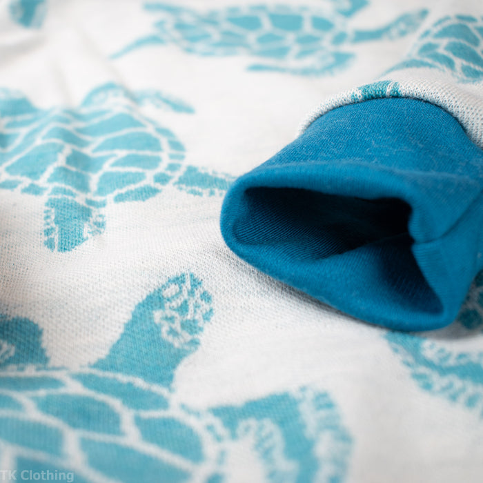 Blue sea turtle print sleeve detail on handmade adventure clothing by TK Clothing Inc.
