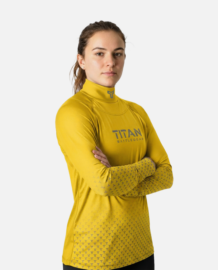 Woman wearing a yellow long-sleeve neck guard shirt with 'Titan' branding on a white background