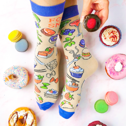 Food Snob Women's Crew Socks. Pilates? Thought you said pie and lattes!  ──────────────── Size Women's shoe size 6-9 Men’s shoe size 4-7 EUR 37-41 ──────────────── Materials & Attributes 70% Combed Cotton, 28% Nylon and 2% Spandex. Reinforced stitching on toe to protect from wear.  Print on Socks: "Food Snob"  ──────────────── Care Machine wash and hang to dry.  Do not iron or bleach.