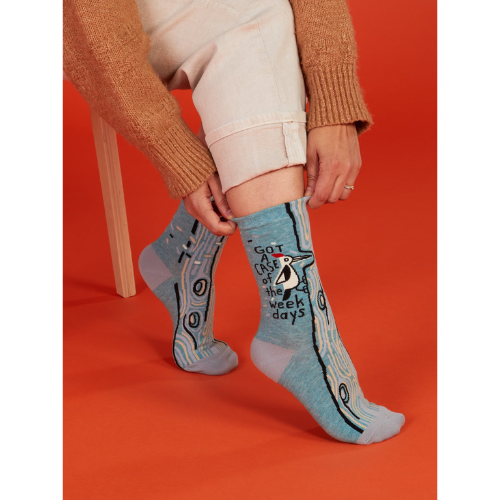 A pair of Blue Q socks with the phrase "Got a Case of the Weekdays," featuring fun graphics and a playful design for those who feel personally attacked by Mondays.