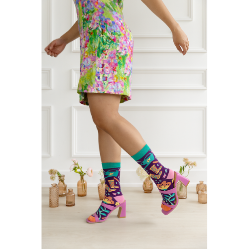 Women's crew socks with colorful gardening-themed designs including flowers, boots, and a watering can from Uptown Sox.