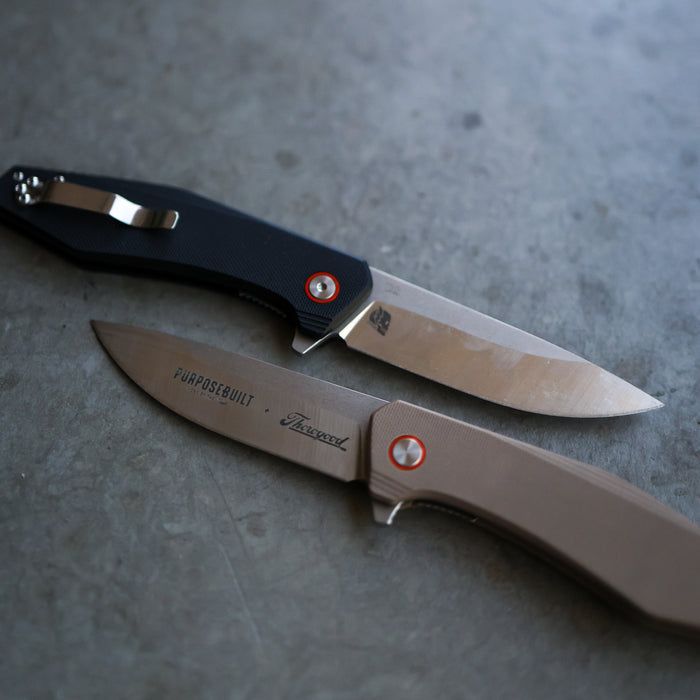 Crimson M6 folding pocket knife, close-up product view of the blade and handle