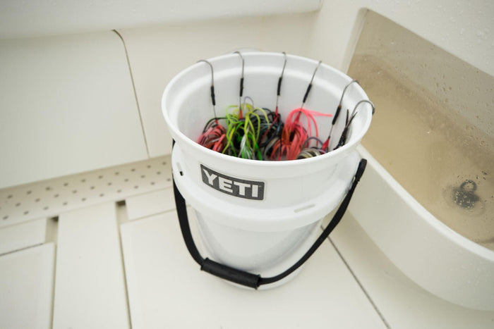 White YETI Loadout bucket shown in use outdoors, lifestyle photo