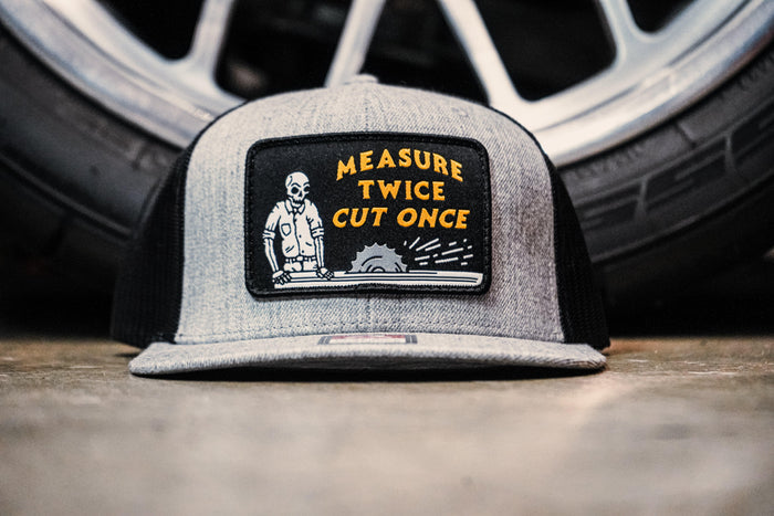 Trade Money Measure Twice Cut Once meshback hat shown worn