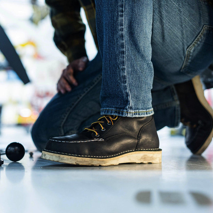 Danner Bull Run 6-inch steel toe work boot in black, shown worn in a lifestyle setting