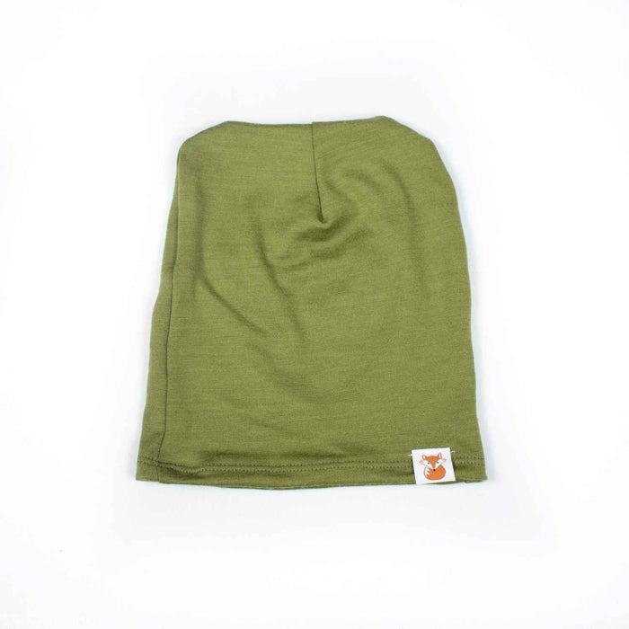 Flay lay shot of the avocado colour merino wool slouchie hat made by TK Clothing