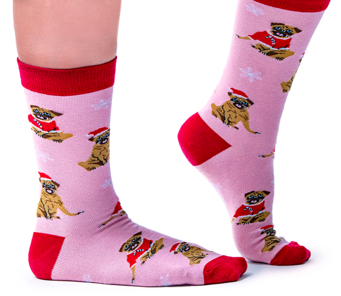 Merry Pug-Mas Socks - Sock Bar. Christmas Pug Socks wearing Santa Hats. Pink background with white snowflakes. Red toes, heels and band.
