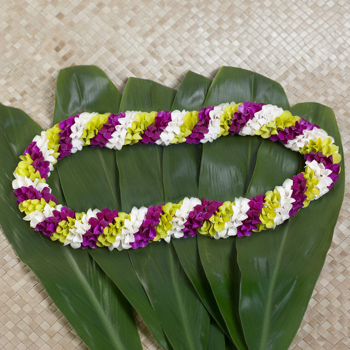 Spiral orchid lei featuring white, green, and purple flowers