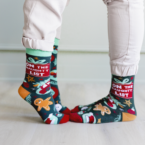 Uptown Sox's 'On the Naughty List' socks featuring fun, cheeky holiday designs, perfect for adding a playful touch to your festive outfits.
