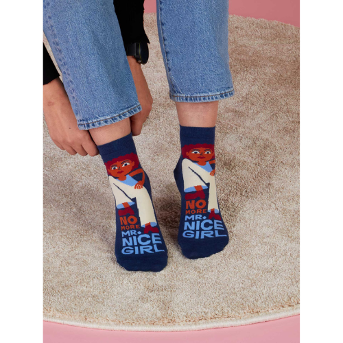 A pair of fierce Blue Q socks featuring the phrase 'No More Mr. Nice Girl' in bold lettering with stylish, empowering graphics.