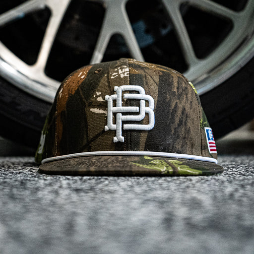 PB Crest rope snapback hat in camo with flat brim, main product view of the front panel