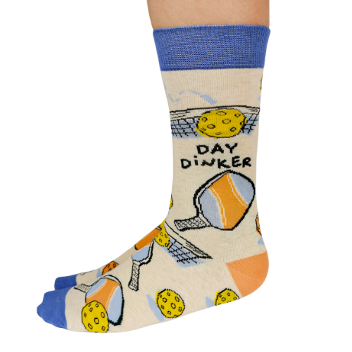 Pickleball-themed socks with vibrant patterns, perfect for players, featuring paddles and balls from Uptown Sox.