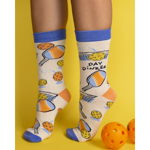 Pickleball-themed socks with vibrant patterns, perfect for players, featuring paddles and balls from Uptown Sox.