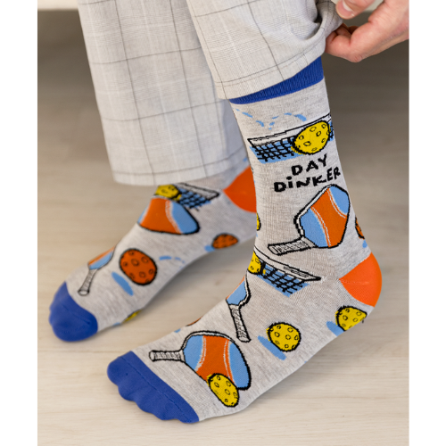 Gray Day Dinker socks featuring colorful pickleball paddles, balls, and nets with a blue cuff and toe design