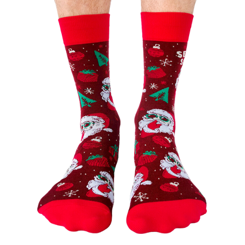 Red and green Secret Santa gift socks featuring a playful Santa design with sunglasses, snowflakes, and festive decorations, perfect for holiday gifting.
