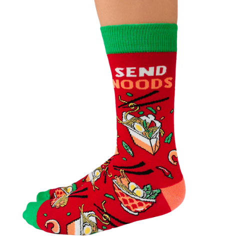Pair of red men's crew socks with green accents, featuring a noodle bowl design and the phrase 'Send Noods,' decorated with chopsticks and noodle imagery.
