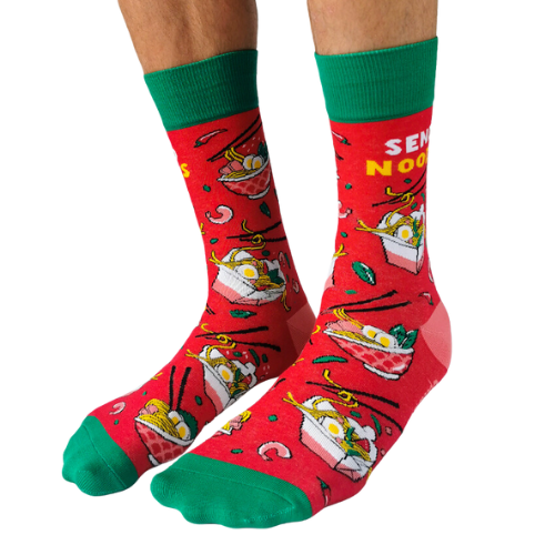 Pair of red men's crew socks with green accents, featuring a noodle bowl design and the phrase 'Send Noods,' decorated with chopsticks and noodle imagery.
