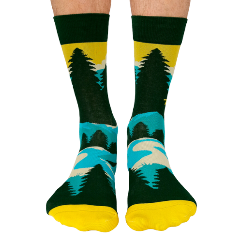 Pair of green, teal, and yellow men's crew socks with a mountain and sun design, featuring the phrase 'Take A Hike' on the side.
