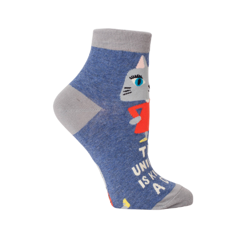 crew socks featuring the phrase “The Universe Is Kind Of A Dick” in bold lettering, designed by BlueQ.