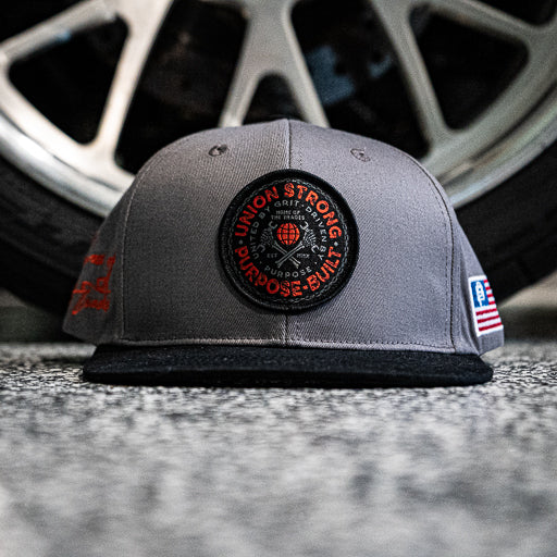 Union Strong flat brim snapback hat in grey and black, main product view of the front panel