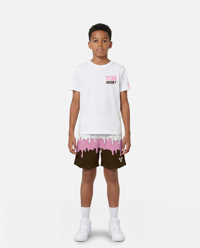 Child wearing a titan battlegear white t-shirt with pink text and brown shorts with ice cream design on a white background